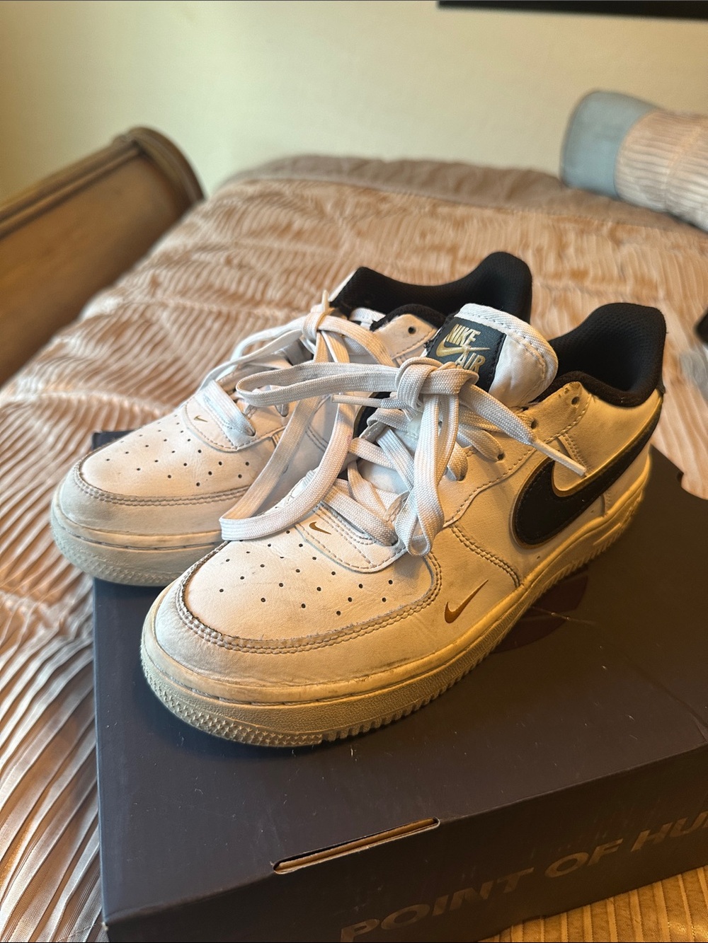 Nike Kids White Sneakers with Black Swoosh and Gold Accents